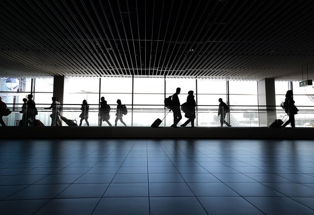 Passengers waiting at an airport departure gate before a flight